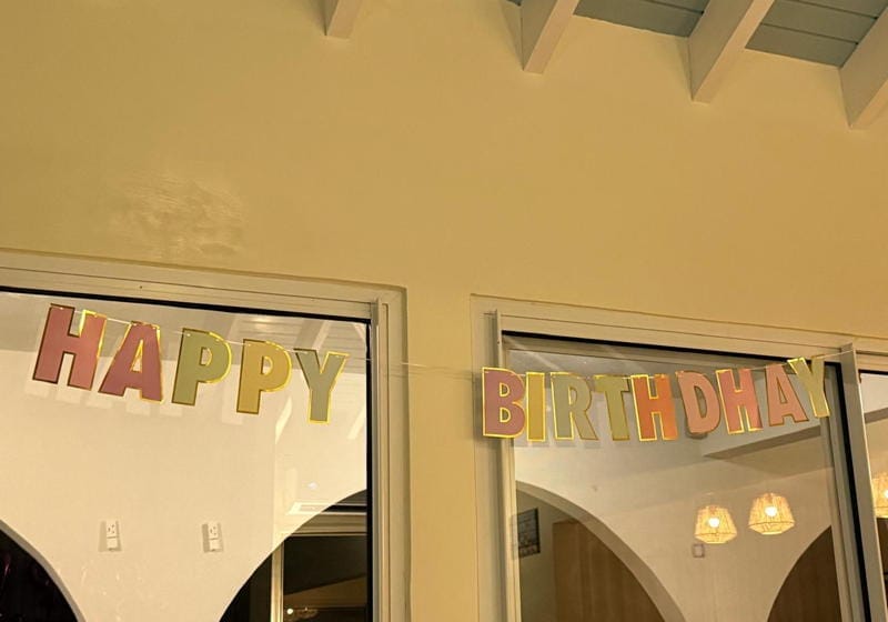 A sign we hung on the murder mansion that says "Happy Birthdhay"
